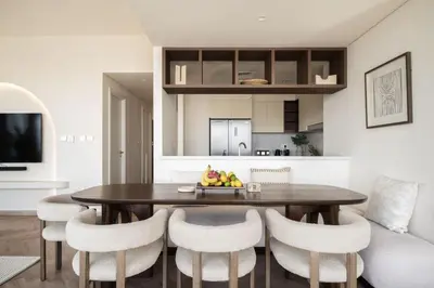 a kitchen and dining room with a table and chairs at Seraya Residence 9 - 4BDR - Skyline and Burj View - 3 Balconies in Dubai