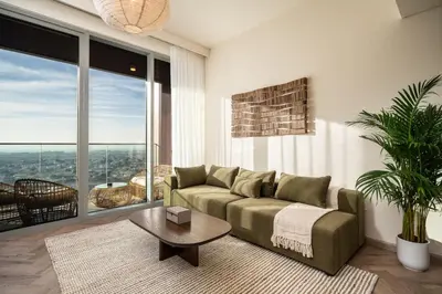 a living room with a couch and a table at Seraya Residences at Forte in Dubai