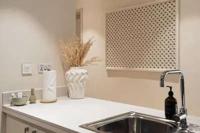 a kitchen counter with a sink and a window at Seraya Residences at Forte in Dubai