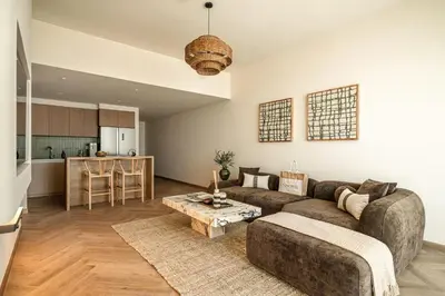 a living room with a couch and a table at Seraya Residences at Downtown Views 2 in Dubai