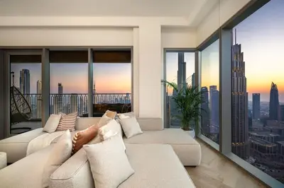 a living room with a white couch and large windows at Seraya Residence 11 - 3BDR - Private Jacuzzi and Infrared Sauna in Dubai