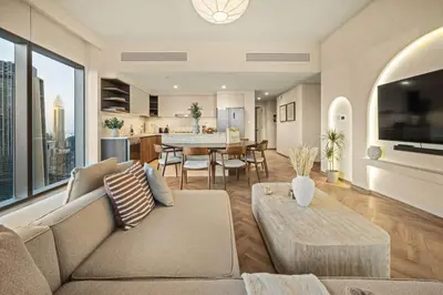 a living room with a couch and a table at Seraya Residence 11 - 3BDR - Private Jacuzzi and Infrared Sauna in Dubai