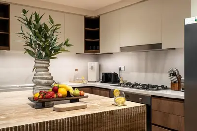 a kitchen with a bowl of fruit on a counter at Seraya Residence 11 - 3BDR - Private Jacuzzi and Infrared Sauna in Dubai
