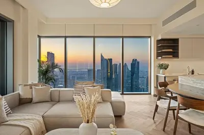 a living room with a couch and a table at Seraya Residence 11 - 3BDR - Private Jacuzzi and Infrared Sauna in Dubai