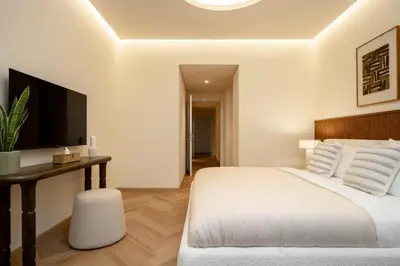 a bedroom with a bed and a desk and a television at Seraya Residence 14 - 4 BDR - Burj Views - Big Balcony in Dubai