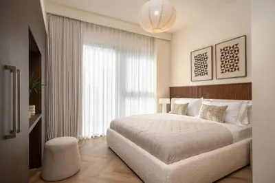 a bedroom with a large bed and a large window at Seraya Residence 14 - 4 BDR - Burj Views - Big Balcony in Dubai