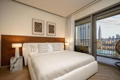a bedroom with a large bed and a large window at Seraya Residence 14 - 4 BDR - Burj Views - Big Balcony in Dubai