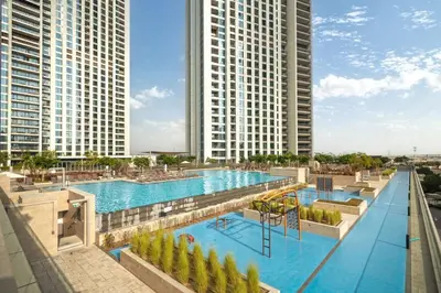 an overhead view of a swimming pool with two tall buildings at Seraya Residence 12 - 3BDR - Hot Tub on patio with Burj view in Dubai