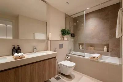 a bathroom with a sink and a toilet and a shower at Seraya Residence 12 - 3BDR - Hot Tub on patio with Burj view in Dubai