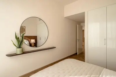 a bedroom with a mirror and a bed at Seraya Residence 15 - 3BDR - Burj View and Dubai Mall access in Dubai