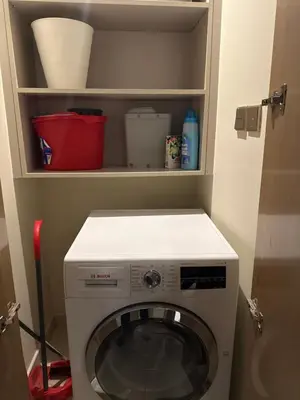 a washer and dryer in a small room at Royal Montania by DAMAC Paramount , Burj Khalifa View in Dubai