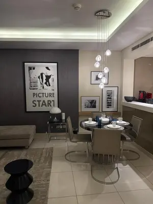 a dining room with a table and chairs at Royal Montania by DAMAC Paramount , Burj Khalifa View in Dubai