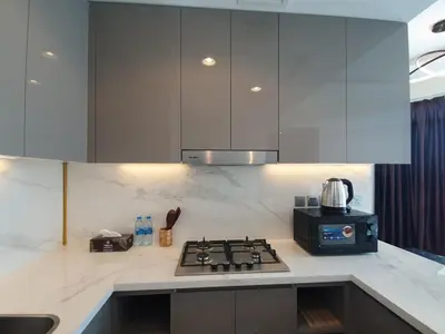 a kitchen with a stove and a microwave at Dubai Skyline & Creek View - Homeyvillas in Dubai
