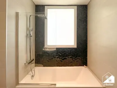 a bathroom with a bath tub and a window at Amazing Stay in AG Tower , Business bay in Dubai
