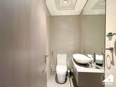 a bathroom with a white toilet and a sink at Luxury At AG Tower Business Bay & City Views in Dubai