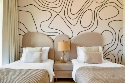 two beds sitting next to each other in a bedroom at Skyline Gem Full Burj View 2BR Suite with Dubai Mall access by Maxx Value homes in Dubai