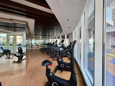 a gym with a row of exercise bikes in it at Dubai Studio Retreat Pool, Gym, Balcony & Queen Bed for Two in Dubai