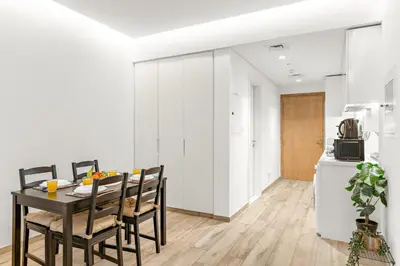 a kitchen and dining room with a table and chairs at Business Bay Studio Near Dubai Mall, Burj Khalifa & Downtown Hotspots in Dubai