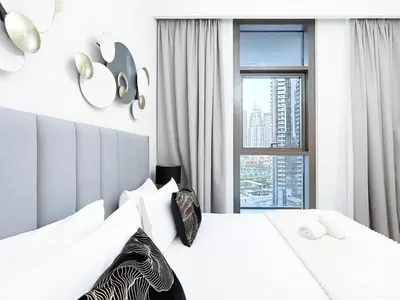 a bedroom with a white bed with a window at Luxurious 2BR in Burj Crown with Burj Khalifa View in Dubai