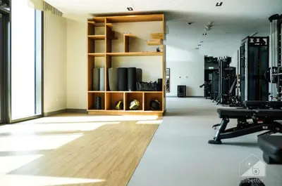 a large room with a gym with wooden shelves at Luxurious 2BR in Burj Crown with Burj Khalifa View in Dubai