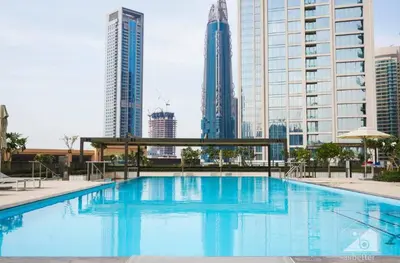 a large swimming pool in a city with tall buildings at Luxurious 2BR in Burj Crown with Burj Khalifa View in Dubai