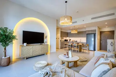 a living room with a couch and a tv at Top floor Grande 2BR Luxe Panoramic Sea View BohemianStyle in Dubai