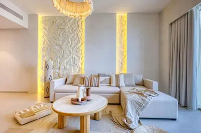 a living room with a couch and a table at Top floor Grande 2BR Luxe Panoramic Sea View BohemianStyle in Dubai