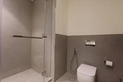 a bathroom with a toilet and a shower at Top floor Grande 2BR Luxe Panoramic Sea View BohemianStyle in Dubai