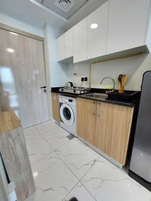 a kitchen with a sink and a washing machine at Urban Studio - Walk to Metro - Homeyvillas in Dubai