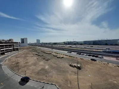 a parking lot with cars parked on a highway at Urban Studio - Walk to Metro - Homeyvillas in Dubai