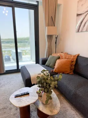 a living room with a couch and a table at COZY 1 BR Apartment in Dubai