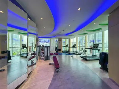 a gym with treadmills and exercise equipment in a building at Near Dubai Mall Downtown Views Infinity Pool in Dubai
