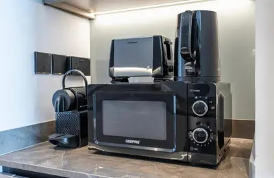 a microwave with a computer on top of it at Gem in the heart of Business Bay - 15 Northside in Dubai