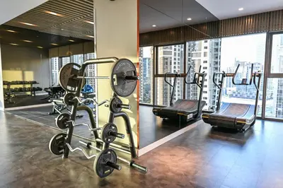 a gym with several tread machines in a building at 2BR Burj Khalifa and Sea View Apartments in Paramount Hotel Midtown in Dubai
