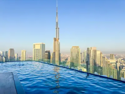 a infinity pool with a view of the city at 2BR Burj Khalifa and Sea View Apartments in Paramount Hotel Midtown in Dubai