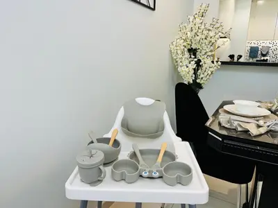 a white table with bowls and utensils on it at 2BR Burj Khalifa and Sea View Apartments in Paramount Hotel Midtown in Dubai
