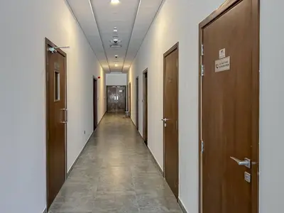 a hallway with wooden doors and a long corridor at Luxurious Serenity 5-Star Lifestyle in JVC in Dubai