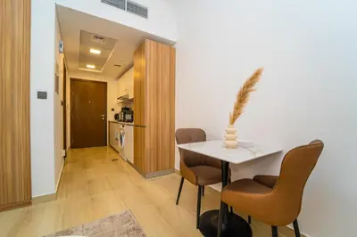 a dining room with a table and chairs at Luxurious Serenity 5-Star Lifestyle in JVC in Dubai