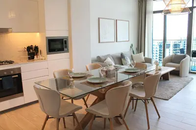 a kitchen and dining room with a table and chairs at Palace Residences luxurious 2 bedroom with breathtaking views in Dubai
