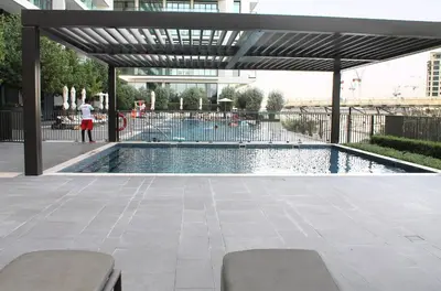 a swimming pool with a canopy over it at Palace Residences luxurious 2 bedroom with breathtaking views in Dubai