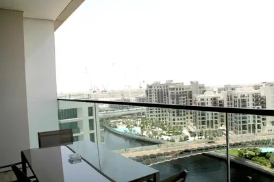 a room with a table and a view of a bridge at Palace Residences luxurious 2 bedroom with breathtaking views in Dubai