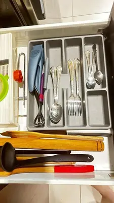 a drawer filled with utensils and utensils at Tranquil & Elegant Studio in Dubai Sports City in Dubai