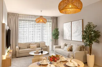 a living room with a couch and a table at Stylish 1BR Apartment near Burj Khalifa and Dubai Fountain, Downtown in Dubai