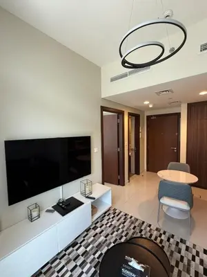 a living room with a large flat screen tv at Stylish 1-Bedroom Apartment near burj khalifa in Dubai