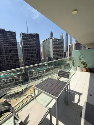 a table and chairs on a balcony with a city skyline at Stylish 1-Bedroom Apartment near burj khalifa in Dubai