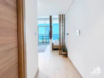 a hallway with a door leading to a bedroom at Balcony Bliss Cozy Studio with Marina Views in Dubai