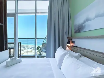 a bedroom with a bed with a view of the ocean at Chic New Studio at Studio One Marina in Dubai