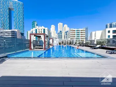 a large swimming pool in a city with tall buildings at New! Cozy & Stylish Studio at Studio One Marina in Dubai
