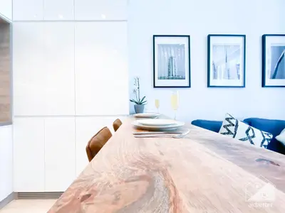 a dining room with a wooden table and chairs at New! Cozy & Stylish Studio at Studio One Marina in Dubai