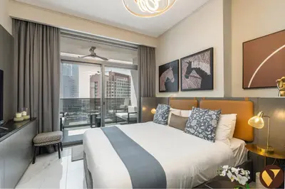 a bedroom with a large bed and a balcony at Vogue Downtown Mag 318 near Burj Khalifa and Dubai Mall, Studio Apartment with Balcony, Canal and City View, Access to all Amenities in Sabkhah